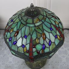 a stained glass lamp sitting on top of a table