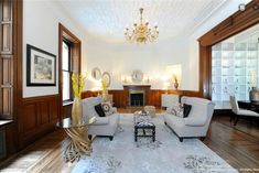 a living room filled with furniture and a chandelier