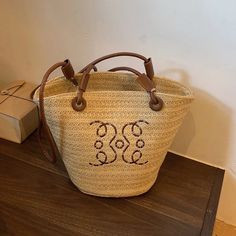 45913308659879 Casual Straw Bag With Top Handle For Shopping, Casual Top Handle Straw Shopping Bag, Tan Straw Bag With Double Handle, Beige Bucket Shape Shoulder Bag With Top Carry Handle, Beige Bucket Satchel For Summer, Casual Woven Satchel For Shopping, Tan Bucket Bag With Braided Handles, Tan Top Handle Bag With Braided Handles, Casual Tan Bucket Shoulder Bag