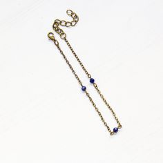 "This dainty gemstone anklet is perfect for the beach but is also delicate enough to wear with a fun dress. Day to night vibes! Lapis lazuli tiny gemstones Nickel-free brass chain - 7.5\" with 2\" extender Lapis lazuli enhances communication, intuition, psychic perceptions and channeling abilities. Used to promote a clear mind and to provide spiritual protection. It possesses enormous serenity and is the key to spiritual attainment and wisdom. Bringing qualities of honesty, compassion and uprigh Dainty Adjustable Nickel-free Anklets, Adjustable Beaded Chain Anklet As Gift, Beaded Bracelet Anklet As Gift, Adjustable Anklet With Lobster Clasp, Blue Beaded Chain Anklets As Gift, Blue Beaded Chain Anklets For Gift, Dainty Adjustable Beaded Chain Anklets, Anklets Boho, Carnelian Necklace