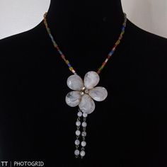 Brand New Handmade Multi Color Glass Beaded Necklace With Large Mother Of Pearl Color Flower Shaped Pendant With Drop Tassels Of Smaller Mother Of Pearl Beads And Silvertone Twist Clasp Approximate Measurements Are Taken With The Item Laying Flat And Are To Be Used As A Guide Only Please Let Me Know You Have Any Other Questions All Items In New Or Gently Used Condition Unless Otherwise Noted Offers Welcome Bundle And Save White Bohemian Jewelry With Flower Decoration, Bohemian White Jewelry With Flower Decoration, White Flower Charm Necklace For The Beach, White Flower Charm Necklace For Beach, Elegant White Flower Beaded Necklace, White Adjustable Flower Pendant Necklace, White Flower Decorated Necklaces For Party, Bohemian White Flower Necklace For Beach, White Flower Pendant Necklace For Parties