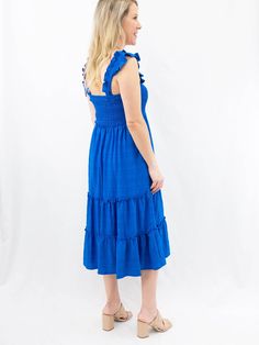 A casual midi dress is perfect for a weekend lunch date or to throw on when you need to look cute without trying. This ruffle sleeve royal blue dress features a smocked chest, tiered ruffle skirt, and midi length. SIZE & FIT Fit is true to size Model is 5'6" wearing size small Ruffled Midi Dress For Vacation, Ruffled Knee-length Midi Dress For Vacation, Knee-length Ruffled Maxi Dress For Vacation, Ruffled Knee-length Sundress, Knee-length Dress With Ruffles For Vacation, Knee-length Sundress With Ruffles, Blue Tiered Skirt Smocked Dress For Summer, Blue Smocked Tiered Skirt Dress For Summer, Blue Smocked Dress With Ruffles And Tiered Skirt