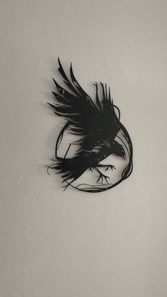 a black and white photo of a clock with a bird on it