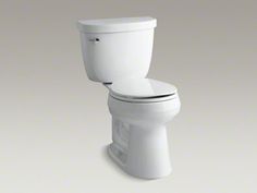 a white toilet sitting on top of a gray floor