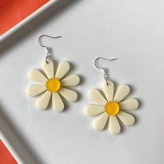 Flower power to the max! These fun, funky oversized flower earrings bring the perfect retro flair to any outfit.  These earrings measure approximately 2.4 inches in length. Each flower is about 1.6 inches in diameter. These earrings feature silver-plated ear wires, so they're great for sensitive ears. Sterling silver is also hypoallergenic and nickel-free.  As if that weren't enough, they're also ultra lightweight, weighing about 4 grams each. Vintage White Flower Drop Earrings, Fun White Flower-shaped Jewelry, White Daisy Flower Earrings For Spring, Trendy Flower Earrings, Cute White Flower Earrings For Spring, Trendy Flower Shaped Earrings, Playful White Flower Earrings, Retro Flower-shaped Earrings For Gift, Retro Flower-shaped Jewelry For Summer