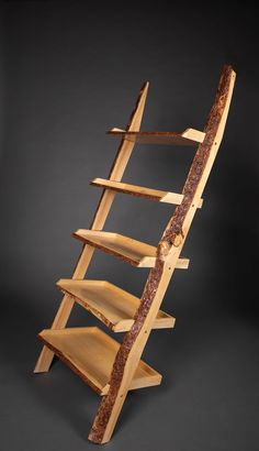 a wooden shelf with three shelves and one is made out of wood, on a black background