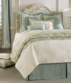 a bed with blue and white comforters in a bedroom