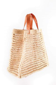 This large bag is ideal for the beach. Handmade crochet in natural raffia, leather handles size: Length: 38 cm Width: 38 cm Side: 18 cm Height handles: 13 cm Weight: -400g Available colors: Natural, tea, grey, navy blue, fushia pink All our products are shipped by mail in colissimo with tracking number. Bohemian Jute Bucket Bag With Open Weave, Bohemian Crochet Tote Bucket Bag, Summer Handmade Natural Fiber Shoulder Bag, Handwoven Tote Shoulder Bag For Beach, Beach Tote Shoulder Bag Handwoven, Bohemian Natural Crochet Bucket Bag, Handmade Natural Fiber Shoulder Bag For Beach, Market Tote Crochet Bag In Natural Fiber, Beachy Beige Crochet Shoulder Bag