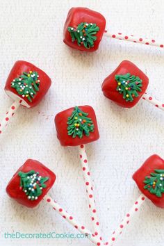 four red candy lollipops decorated with christmas decorations