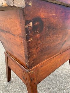 an old wooden box sitting on the ground