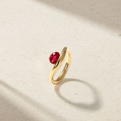 Resting elegantly at the heart of this nouveau design is a vibrant oval shaped ruby cradled within the soft curvature of the shank. The sculptural form presents a clean yet striking statement that has been designed with ease of wearability in mind. This is the quintessential choice for daily wear. Metal: 18kt Gold Ruby Weight: 0.95 ct. Measurements: 9.0 mm length *Please note that the listed ct. weights are approximate and may be subject to slight variations. Luxury Oval Ruby Ring With Polished Finish, Luxury Oval Ruby Birthstone Ring, Modern Yellow Gold Ruby Ring For Formal Events, Luxury Ruby Ring With Round Cut Birthstone, Elegant Ruby Ring With Polished Finish, Modern Yellow Gold Ruby Ring For Formal Occasions, Luxury Round Cut Ruby Birthstone Ring, Timeless Polished Ruby Ring, Modern Ruby Ring For Formal Occasions