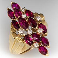 This vintage cluster ring features twelve (12) two-prong set, marquise cut rubies that are accented with seven (7) round brilliant cut diamonds. The shoulders feature a graduated, tiered design. The ring measures 36.4mm at the top, rises 13.6mm above the finger, tapering to 4.3mm wide and 1.9mm thick at the base of the shank. It is currently a size 8.25 with a spring ring insert. Marquise Multi-stone Cluster Ring For Formal Occasions, Formal Marquise Multi-stone Cluster Ring, Formal Marquise Cluster Ring With Multi-stone, Formal Red Marquise Cut Cluster Ring, Formal Marquise Multi-stone Ruby Ring, Formal Multi-stone Marquise Ruby Ring, Vintage Cluster Ring, Designer Diamond Jewellery, Precious Jewels