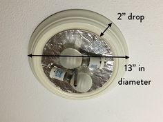 an image of a ceiling fan with measurements for the light bulb and two droprs