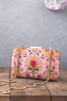 "Our Alanna clutch is detailed with thread and zari and sequin embroidery on soft silk. Pair this with a vibrant pink ensemble and watch it stand out as a statement accessory! Embroidered front and back. Dimensions (LxB): 8\"x4\" Handle length: 47\" Handle drop: 23\" Material: Embroidery pure silk, suede lining, golden metal clutch frame, golden metal sling. Features: metal lock closure, detachable metal sling." Ladies Purses Handbags Style, Hand Bags For Women, Pumpkin Patch Outfit, Potli Bag, Step By Step Crochet, Pink Clutch, Cap Patterns, Potli Bags, Designer Clutch