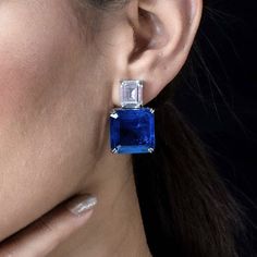 Sapphire earrings featuring semi precious blue doublet stone and cz diamonds. Ideal jewelry to pair with your bridal wedding gown or any special occasion outfit. These LUXURY Earrings surely elevate your look. Perfect gift for her. *𝐏𝐑𝐎𝐃𝐔𝐂𝐓 𝐃𝐄𝐓𝐀𝐈𝐋* * 𝐌𝐚𝐭𝐞𝐫𝐢𝐚𝐥: Brass * 𝐏𝐥𝐚𝐭𝐢𝐧𝐠: White Rhodium Plated * 𝐒𝐭𝐨𝐧𝐞: AAA-quality CZ Diamond & Sapphire. *𝐃𝐈𝐌𝐄𝐍𝐒𝐈𝐎𝐍𝐒* * 𝐖𝐞𝐢𝐠𝐡𝐭: 13 gm each * 𝐋𝐞𝐧𝐠𝐭𝐡: 1.15 Inches * 𝐖𝐢𝐝𝐭𝐡:  0.65 Inches * 𝐂𝐥𝐨𝐬𝐮𝐫𝐞: P Blue Earrings Wedding, Blue Diamond Earrings, Blue Bridal Earrings, Bride Wedding Gift, Blue Bride, Blue Sapphire Jewelry, Blue Sapphire Studs, Sapphire And Diamond Earrings, Sapphire Earrings Studs