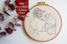 the embroidery pattern is being displayed next to some flowers