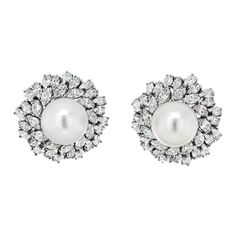 Behold the epitome of elegance and luxury with the Van Cleef & Arpels Estate Diamond and Pearl Bombe Earrings, a breathtaking testament to the artistry of fine jewelry. Crafted in exquisite 18k white gold, these earrings exude an aura of timeless sophistication that is synonymous with the Van Cleef & Arpels legacy. At the heart of these masterpieces lies a luminous white pearl, commanding attention with its impressive 16mm diameter. The pearl's pristine radiance is further enhanced by the opulence of its surroundings – a halo of meticulously arranged marquise-cut diamonds. With a total carat weight of approximately 20.00cttw, these diamonds glisten like celestial stars, adding an awe-inspiring brilliance to the earrings. The unique bombe design of the earrings accentuates their regal prese Earring Video, Gold Vans, Van Cleef & Arpels, Diamond Cluster Earrings, Pearl And Diamond Necklace, Van Cleef And Arpels, Earring Stand, White Gold Set, Pearl And Diamond Earrings