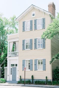 an old house with shutters on the windows