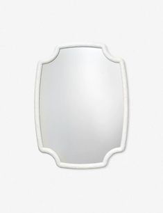 an oval mirror with white trim around the edges on a white wall mounted fixture, viewed from above