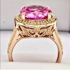 Out Of This World Vivid Pinkovaltopaz Ring Main Stone Carat Weight: 8.21ctw Type: Vivid Pink Topaz-Lab Created Shape: Oval Cut Color: Pink Clarity: Vs Accent Stones: White Topaz Accent Carat Weight: .01ctw Shapes: Round Color: White Clarity: Vvs More Details Total Carat Weight: 9.00ctw North To South: 18.4mm Height Above Finger: 10.2mm Shank Width: 2mm Finger Size: 8 Gram Weight: 7.5g Material: 14k Rose Gold Over 925 Sterling Silver *Retail Value: $499 Luxury Pink Oval Diamond Ring, Oval Pink Sapphire Diamond Ring With Accents, Luxury Pink Topaz Ring For Formal Occasions, Pink Oval Diamond Ring With Center Stone, Pink Sapphire Ring With Halo Design For Formal Occasion, Formal Pink Sapphire Ring With Halo Design, Pink Oval Diamond Ring With Accent Stones, Pink Oval Diamond Ring With Dazzling Style, Oval Pink Diamond Ring With Accent Stones