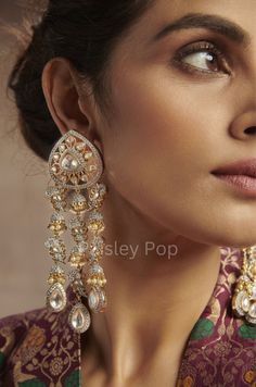 The uncut polki danglers are handcrafted by the artisans of India to create a perfect romance between classic and modern concepts of Indian jewelry. The beautiful work of art in a melange of polki and faux diamonds transcends the boundary of age and time that speak the language of opulence. Add this classic pair, which is inspired by cocktail evening jewelry to your bijoux box and make it your companion for your special days. The gold and silver tone of the earrings add playful elements to the j Kundan Chandelier Earrings For Reception, Festive Chandelier Earrings With Stone Work For Reception, Temple Jewelry Style Chandelier Earrings For Party, Temple Jewelry Style Danglers With Stone Work For Reception, Fusion Style Rose Cut Diamond Earrings For Festive Occasion, Hand Set Chandelier Earrings For Festivals And Receptions, Festive Stone Work Chandelier Earrings For Reception, Reception Temple Jewelry Danglers With Stone Work, Hand Set Chandelier Earrings For Receptions And Festivals