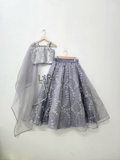 -Cute handcrafted grey colored lehenga with matching stylish sequence top is what you need for your little princess to attend the next festive or wedding gathering. -Both top and bottom have cotton and satin linning for comfort. -Please go through the size chart before placing the order, or you can text me the custom measurements if required. Feel free to ask any questions on etsy convo. I'll glad to help you out. Silver Organza Lehenga For Eid, Silver Party Dresses For Diwali, Festive Gray Diwali Outfit Sets, Gray Festive Sets For Diwali, Gray Wedding Sets For Eid, Festive Gray Sets For Eid, Festive Gray Lehenga With Zari Work, Party Organza Lehenga For Eid, Organza Lehenga For Eid Party