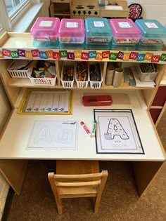 a desk with several plastic containers on top of it and some writing paper in front of it