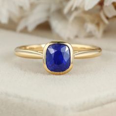 Indulge in luxury with our 14K Yellow Gold Cushion Cut Blue Sapphire Ring for Women. This captivating piece combines opulence and sophistication, featuring a mesmerizing blue sapphire gemstone elegantly set in lustrous yellow gold. Timeless Blue Sapphire Ring In 14k Gold, Timeless Blue Sapphire Birthstone Ring, Elegant Gold Ring With Lab-created Sapphire, Yellow Gold Sapphire Ring With Cushion Cut, Timeless Polished Sapphire Ring, Cushion Cut Sapphire Ring In Yellow Gold, Classic Ethical Sapphire Ring, Luxury Gold Solitaire Sapphire Ring, Luxury Yellow Gold Sapphire Solitaire Ring