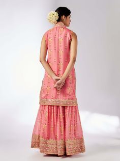 This pretty ensemble of floral jaal, with intricate border embroidery. The sleeveless kurta is embellished down the front and tried with a smart pleated magzi to finish the neckline and armhole. The flowing sharara bottom with gota embroidery still has a lot of flounce and flow. Sleeveless Sharara With Dupatta For Eid, Sleeveless Sharara With Gota Work For Festivals, Sleeveless Chanderi Palazzo Set For Navratri, Festival Sleeveless Sharara With Gota Work, Sleeveless Chanderi Sets With Gota Work, Sleeveless Resham Embroidery Sharara For Festivals, Sleeveless Anarkali Sharara For Festive Season, Sleeveless Chanderi Traditional Wear With Chikankari Embroidery, Chanderi Sleeveless Sets With Dupatta