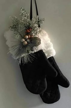 a pair of black and white socks hanging from a wall with christmas decorations on it