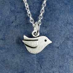 "This sweet little bird is made of sterling silver.  This is one of our TINIEST designs, measuring just under 3/8\" in height (0.9 cm).  Itsy bitsy, and super cute! You can purchase just the pendant, or complete the necklace with a sterling silver chain. © Stick Man Creations This is our own original design, handcrafted by us, and signed on the back with our logo.   For more information about the creative process, click here:  www.etsy.com/shop/StickManJewelry/about CANADIAN ORDERS:  Please note that GST and HST are included in the price, but provincial taxes are not." Cute Silver Pendant Charm Necklace, Cute Sterling Silver Pendant Charm Necklace, Cute Sterling Silver Pendant Charm Necklaces, Cute Silver Sterling Silver Charm Necklaces, Small Sterling Silver Charm Necklace, Cute Nickel-free Sterling Silver Necklaces, Cute Silver Charm Necklaces, Handmade Cute Sterling Silver Charm Necklaces, Cute Nickel-free Silver Charm Necklace