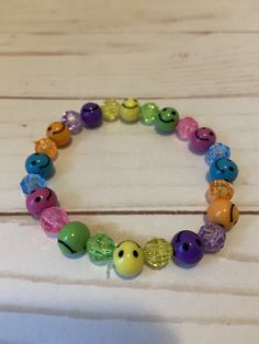 This smiley face beaded bracelet would make a cute gift for a teen or women's Birthday. They would make a great gift for Mother's Day.  It has blue, yellow, purple, orange, and green smiley face beads. It has blue, yellow, purple, orange, and green 8mm faceted beads. It was made with .8mm sturdy stretch string. I tie it several times to prevent breakage.  It fits most women and teens. It stretches to fit on the wrist. All items are ready to be shipped I do combined shipping. Items ship in 2-5 business days. Check out more items at: http://www.etsy.com/shop/MesheleCrafts  https://www.facebook.com Casual Charm Bracelet With Round Beads For Friendship, Cheerful Multicolor Adjustable Jewelry, Casual Friendship Charm Bracelet With Round Beads, Fun Beaded Bracelets With Round Beads, Fun Colorful Beads Bracelets For Everyday, Everyday Cute Stretch Bracelet With Colorful Beads, Casual Adjustable Beaded Bracelets For Birthday, Playful Beaded Stretch Bracelet, Adjustable Beaded Fun Jewelry