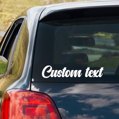 a car with the word custom text on it's side window sticker in white