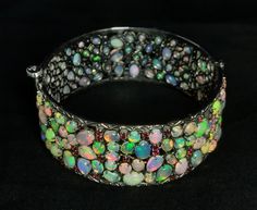 Natural Ethiopian Opal - 925 Silver Bangle. Description:- 925 Sterling Silver, Opal Stone Bangle, Gifted Bangle, Gift For Girl, Woman Fine Jewelry. Gross weight - 49.320 Gram Silver weight - 38.620 Gram Opal weight - 49.30 Carat Rhodolite stone weight - 4.20 Carat Shape of stone - as shown these images Cut Grade - Smooth Quality - AAA Origin - Ethiopia Opal Hardness - 5.5 - 6.5 Color - Multi Color Bangle size - See variation select your Wrist Size                                        ( Home Pa Opal Bangle, Gemstone Bangle, Wedding Gift Baskets, Stone Bangle, Silver Bangle, Silver Bangles, Opal Gemstone, Ethiopian Opal, Gifts For Girls