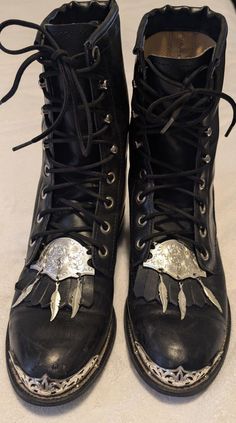 Very unique vintage boots from Texas brand. These real leather lace up boots are made in the USA and feature amazing silver accents of a toe cap and ornate medallion with 3 hanging feathers. The medallion is laced onto the fringed kiltie tongue which can be removed just by undoing the laces. I have not found another pair of boots like these with the kiltie and medallion. The tag says size 5 D which is wide width so they probably fit more like a 6. Please ask if you want measurements. With the kiltie and silver they have  a western vibe but if those are removed they could go boho or many other styles. In good vintage condition with expected wear and no major flaws. These boots have a lot of life left in them. The leather could be polished up to look almost new. Please see pics for details. Gothic Cowboy Boots, Hanging Feathers, Laceup Boots, Hippie Boots, Leather Motorcycle Boots, Black Cowboy Boots, Womens Booties, Boho Boots, Booties Ankle Boots