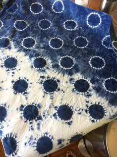 a blue and white tie - dyed table cloth with circles on it