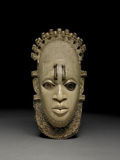 an african mask is shown against a black background