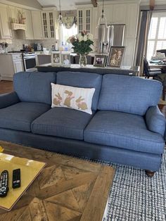 a blue couch in a living room with a wooden coffee table