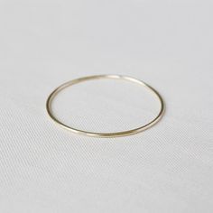 The Double Weight – Yearly Company Everyday White Gold Bangle, Modern Stackable Round Bangle, Minimalist Stackable White Gold Bangle, Gold Hoop Bangle In Minimalist Style, Minimalist Gold Hoop Bangle, Minimalist Gold Hoop Bracelet, Minimalist Stackable Hoop Bangle, Minimalist Stackable Round Band Bracelets, Minimalist Stackable Round Bangle