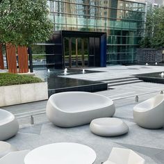 modern outdoor furniture sits in front of a building