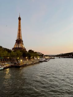 the eiffel tower is lit up at night