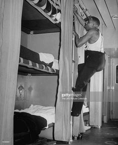 a man climbing up the side of a bunk bed