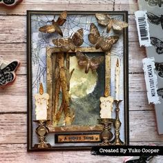 an altered picture frame with butterflies on it and some other items around it, including scissors