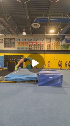 a person on a trampoline in a gym