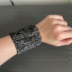 a person's arm with a bracelet on it