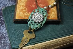 This one of a kind upcycled assemblage necklace features a vintage brass Chicago key, a re-purposed vintage crystal rhinestone button attached to a verdigris patina filigree and vintage glass champagne colored pearls. All hand wrapped together with antiqued brass wire.  Steampunk style with a glam edge!  Measures approximately 19 3/4"  Thank you for looking, see my shop for more: labellesavage.etsy.com Follow on Instagram @labellesavage If you like sculptural jewelry visit my new shop at hollyla Vintage Key Jewelry, Key Necklace Vintage, Colored Pearls, Glass Champagne, Sculptural Jewelry, Assemblage Necklace, Style Steampunk, Vintage Key, Key Jewelry