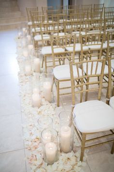 the aisle is decorated with candles and flowers