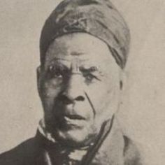 an old black and white photo of a man wearing a turban, looking at the camera