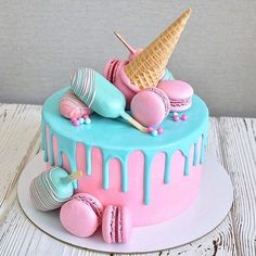 a cake decorated with ice cream, macaroons and donuts