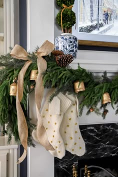 stockings hung on the mantle with christmas decorations